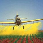 Photo of plane spraying crops
